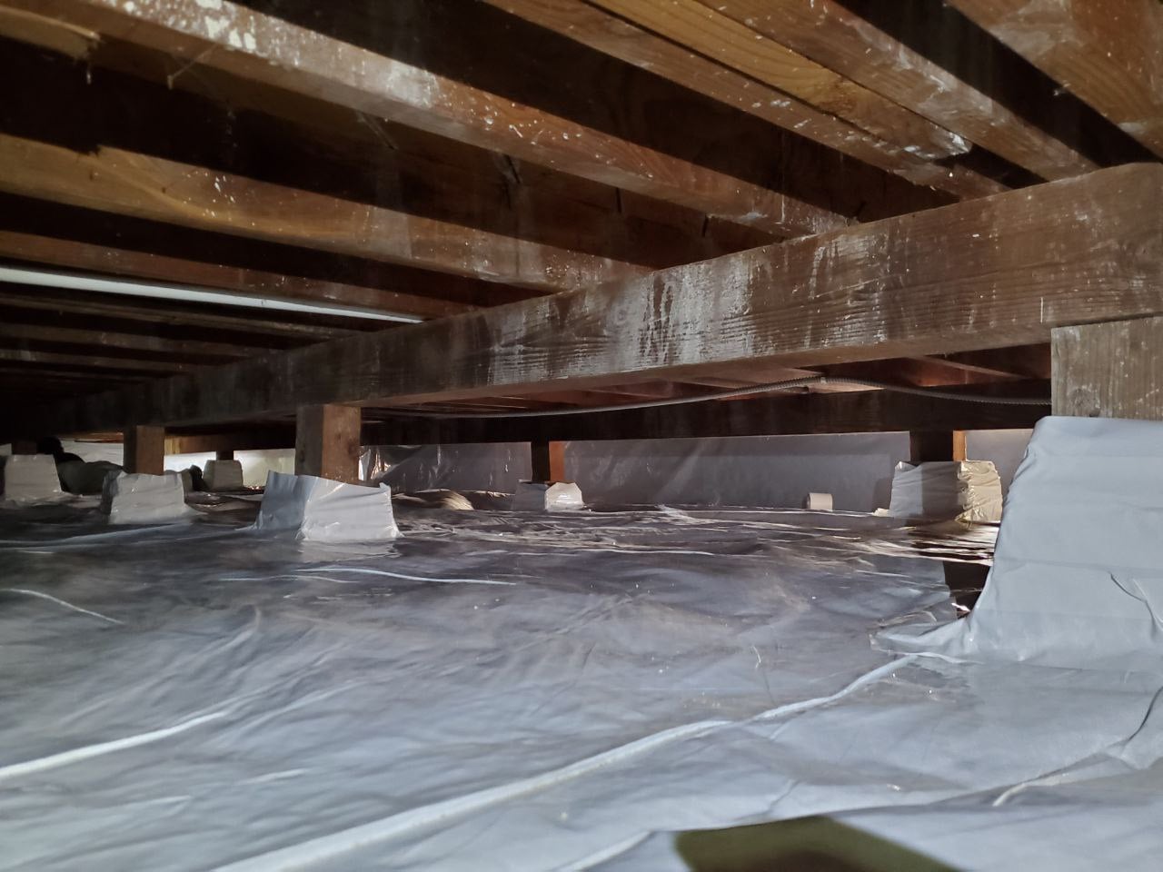 Clean crawl space with vapor barrier installed — professional remediation result in Bay Area home