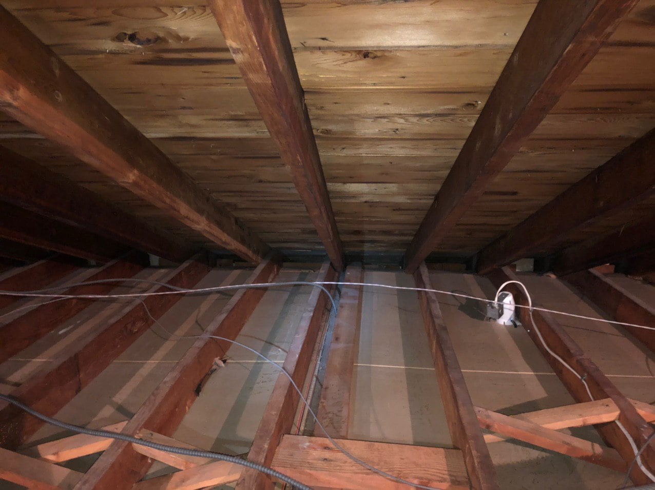 Fresh fiberglass batt insulation installed after attic assessment and preparation