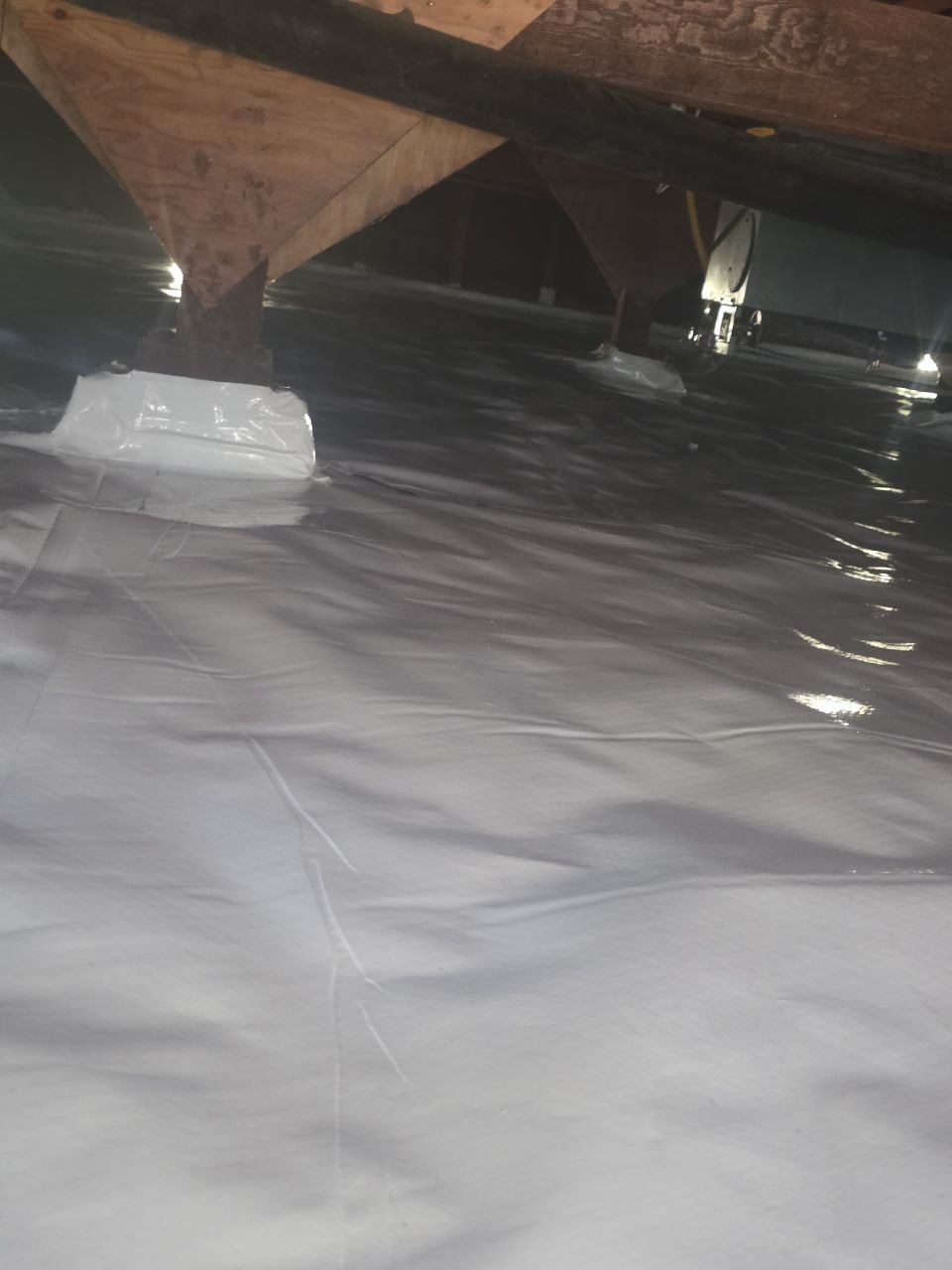 Vapor barrier sealed around crawl space piers in Alameda