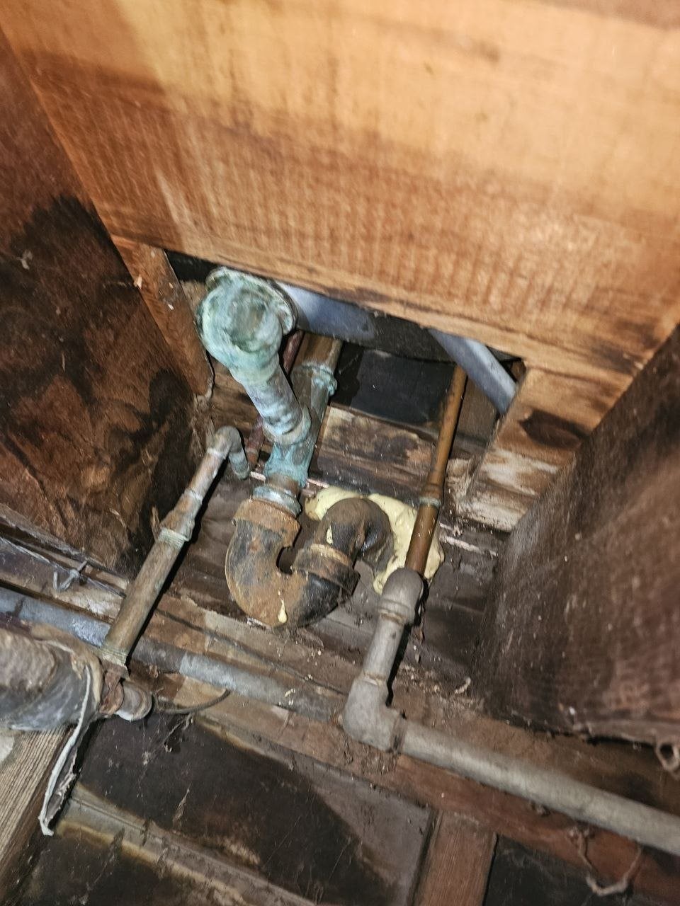 Unsealed opening around plumbing in a Alameda crawl space before work