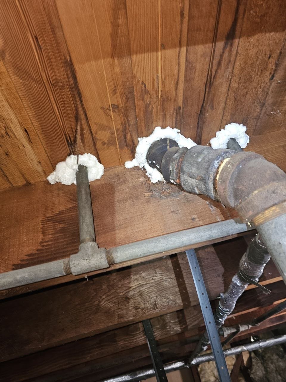 Foam air sealing around an attic penetration in Alameda