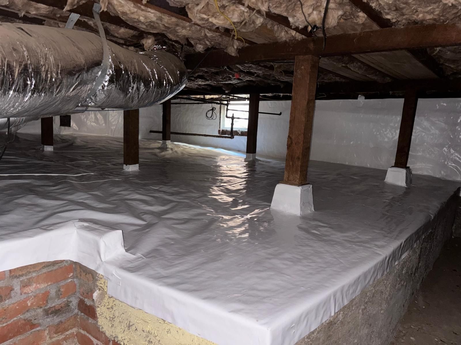 Vapor barrier over a foundation ledge in a Altadena crawl space
