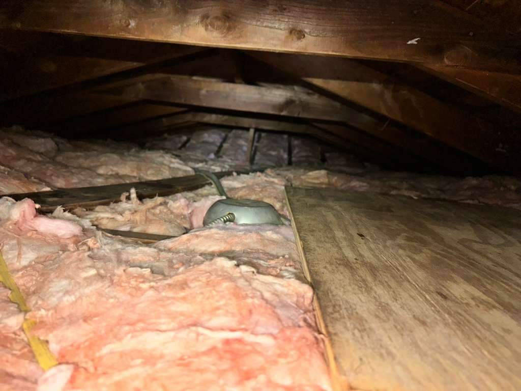 New insulation batts up to the platform in a Anaheim attic