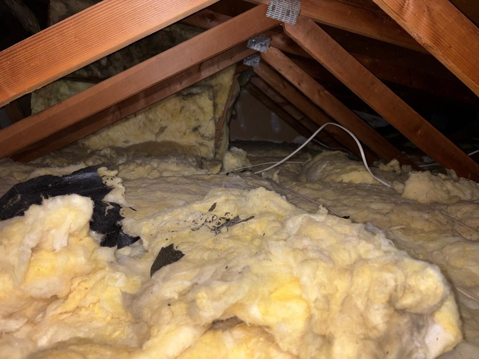 Contaminated old insulation in the Anaheim attic before work