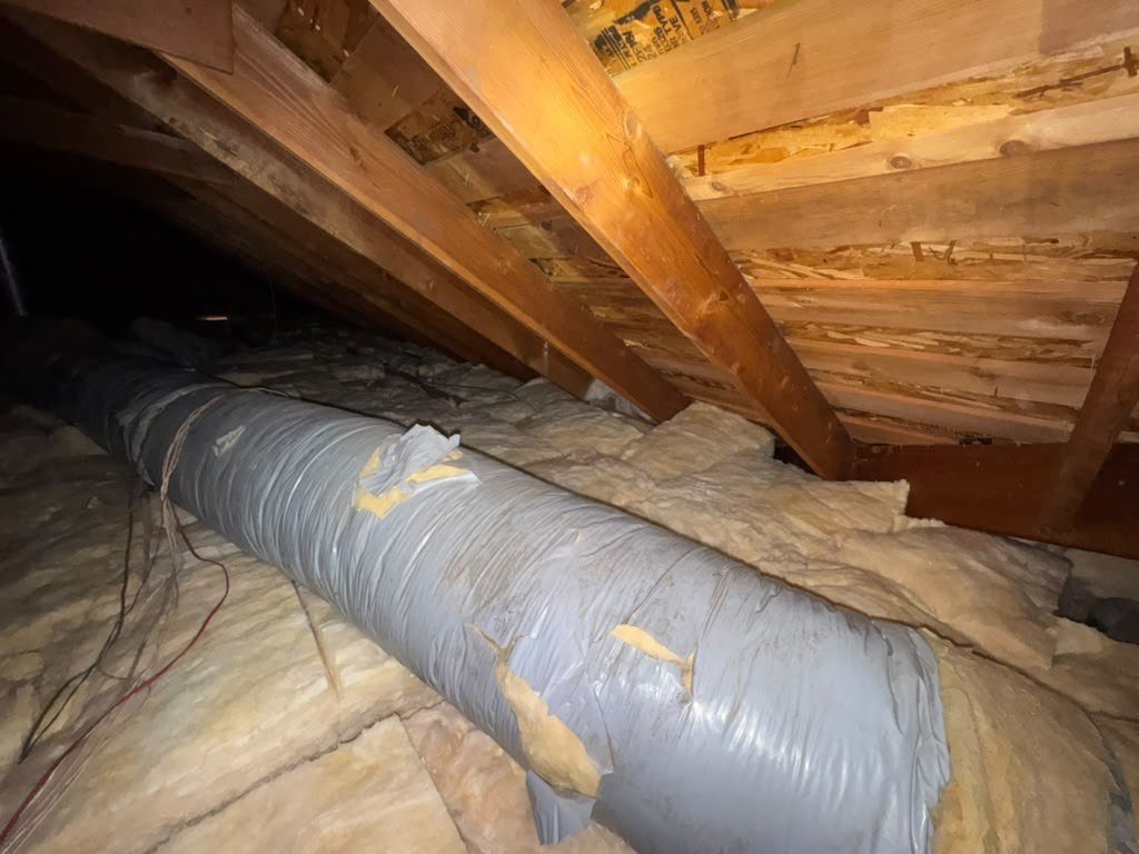 New insulation laid around ducts in a Anaheim attic