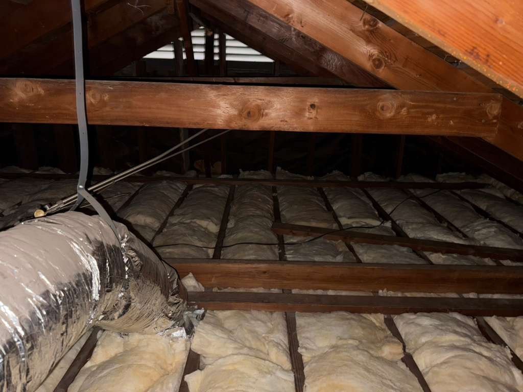 New insulation laid around ducts in a Anaheim attic