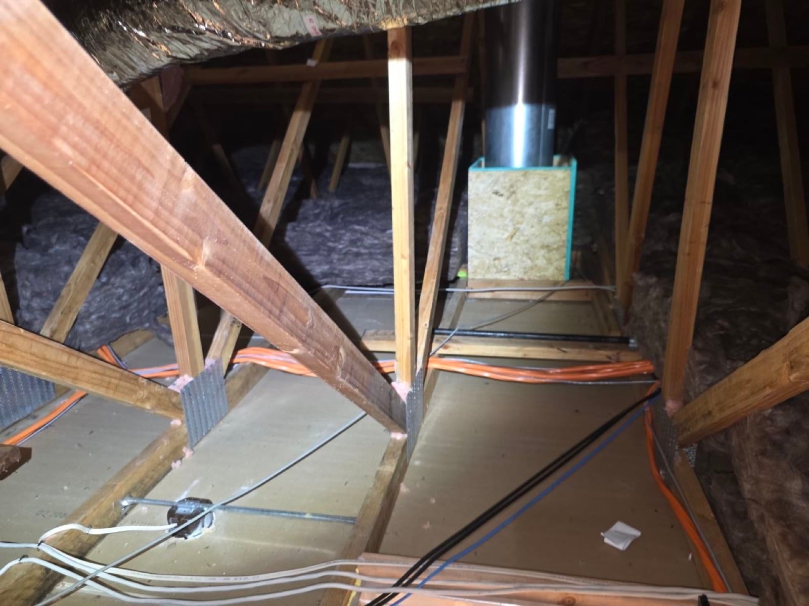 Tracy attic with the whole-house fan flue set through the roof deck
