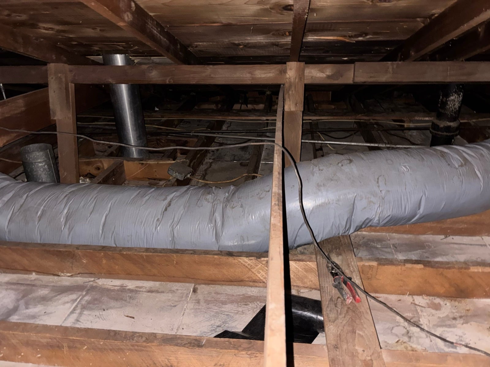 Duarte attic with the new air ducts run over the joists