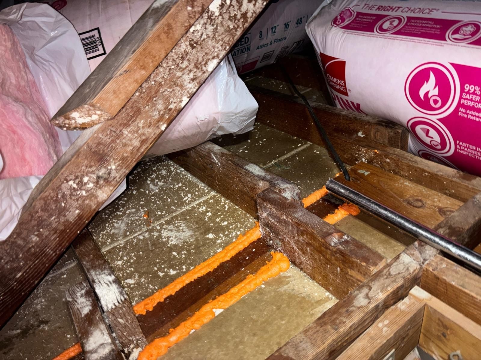 Lawndale attic part way through removal, old material and debris with the new batts on site