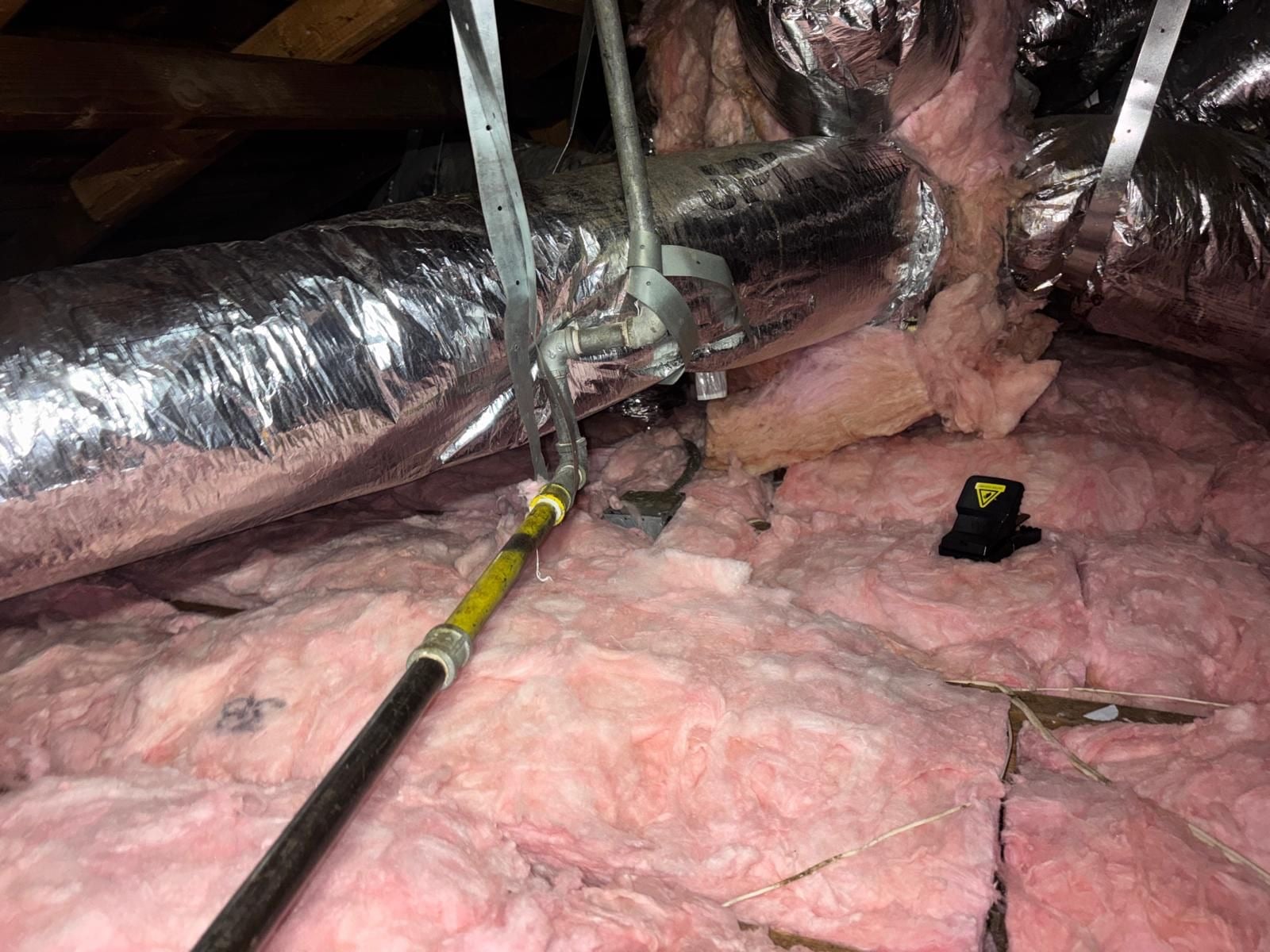Los Angeles attic with the new insulation going in
