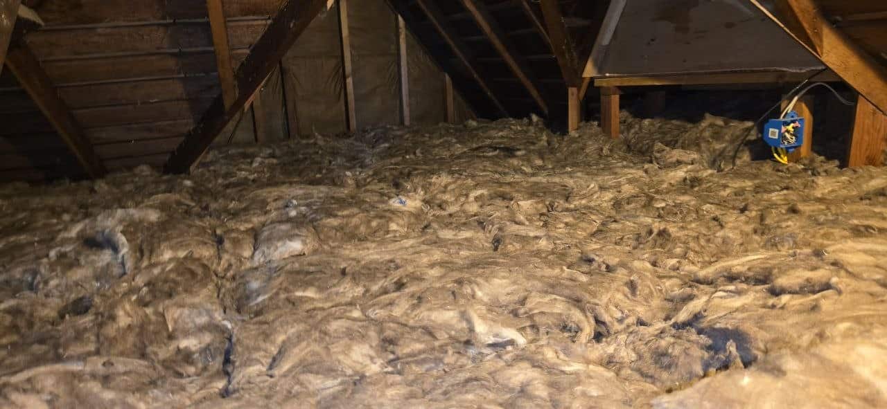 Berkeley attic before work: old, settled insulation across the attic floor
