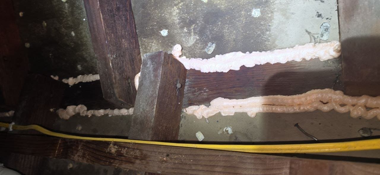 Polyurethane foam air sealing along the attic framing in a Berkeley home