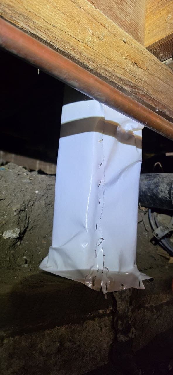 Vapor barrier wrapped and sealed around a crawl space pier