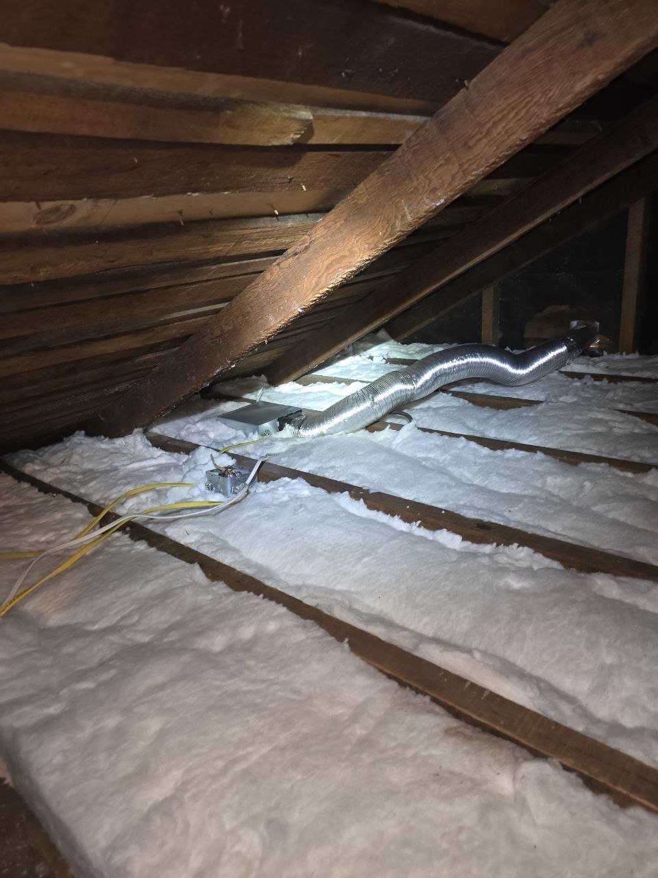 New insulation laid around ducts in a Berkeley attic