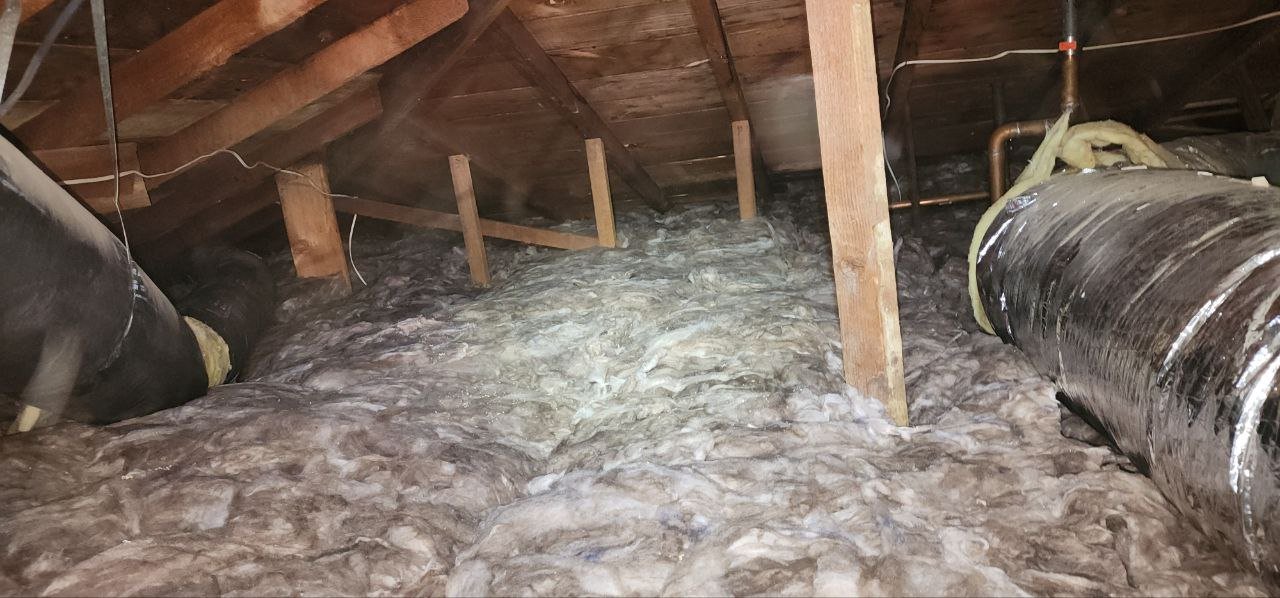 New insulation laid around ducts in a Berkeley attic