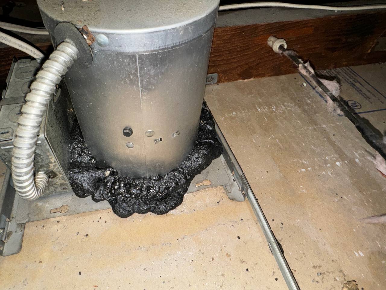 Sealed fixture housing in a Berkeley attic