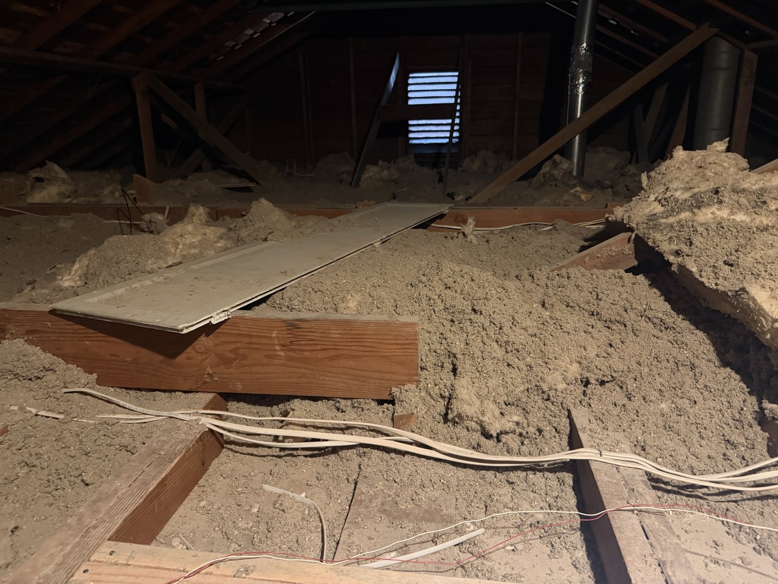 Berkeley attic before work, old insulation and debris
