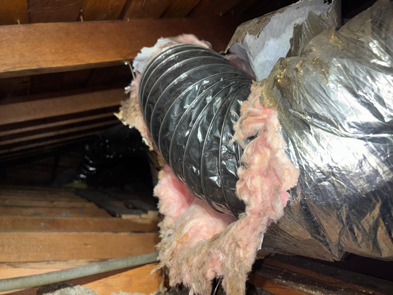Old air duct with split wrap in a Burbank attic before work