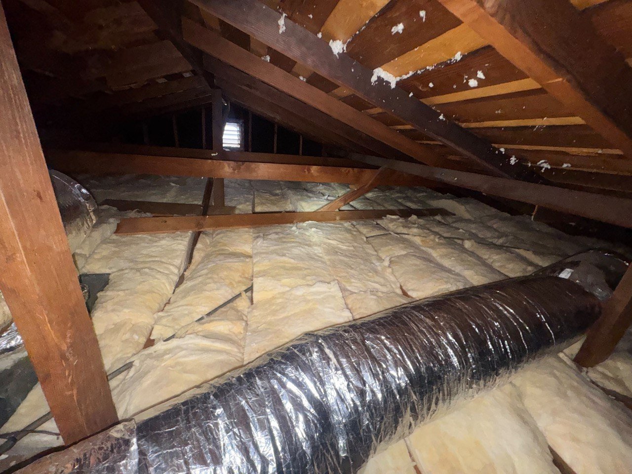 New insulation laid around ducts in a Burbank attic