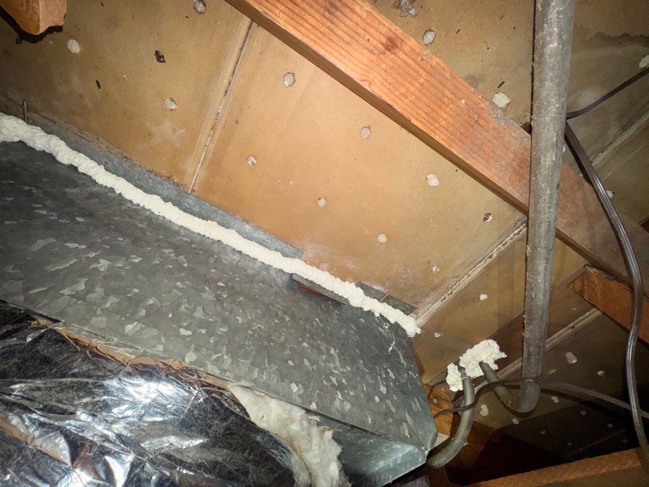Polyurethane foam sealing along an attic duct in Burbank