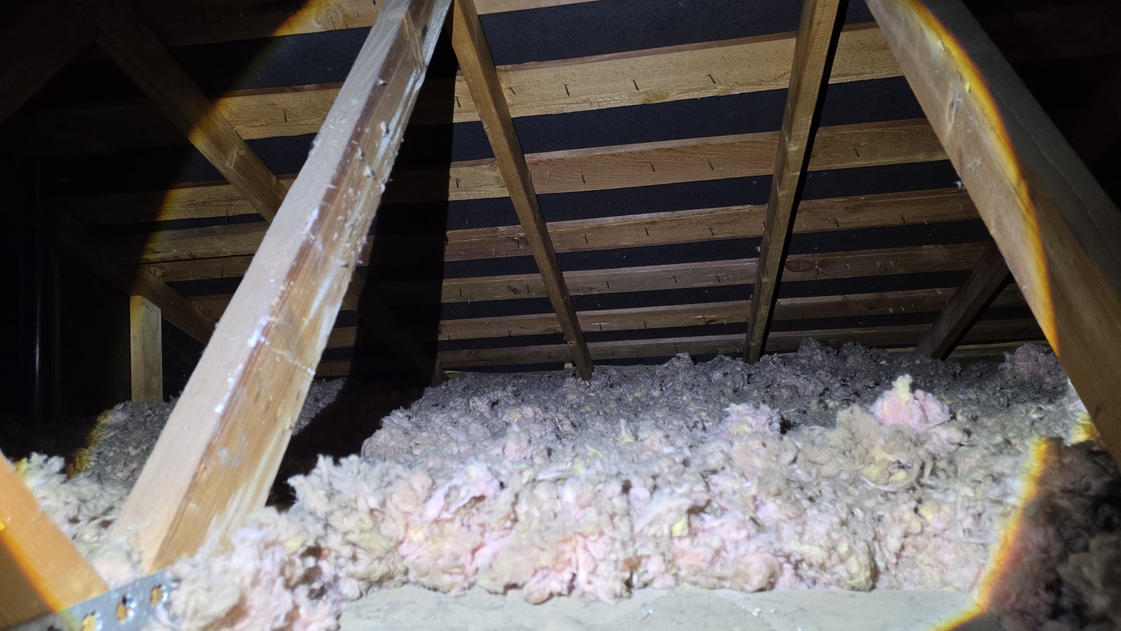 Another area of old insulation in the Concord attic before work