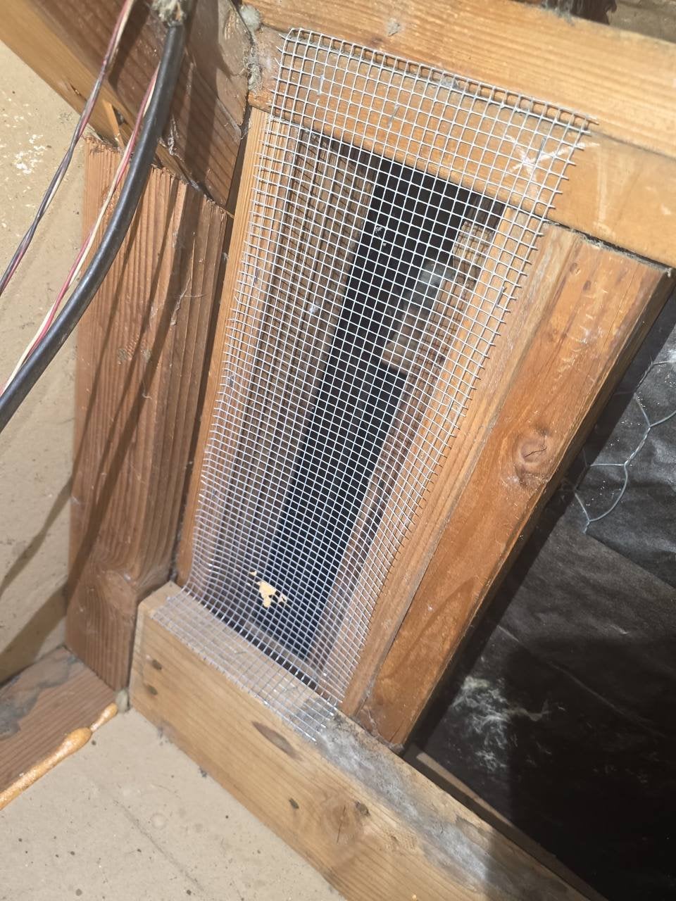 Wire mesh over a framing opening in a Fairfield attic