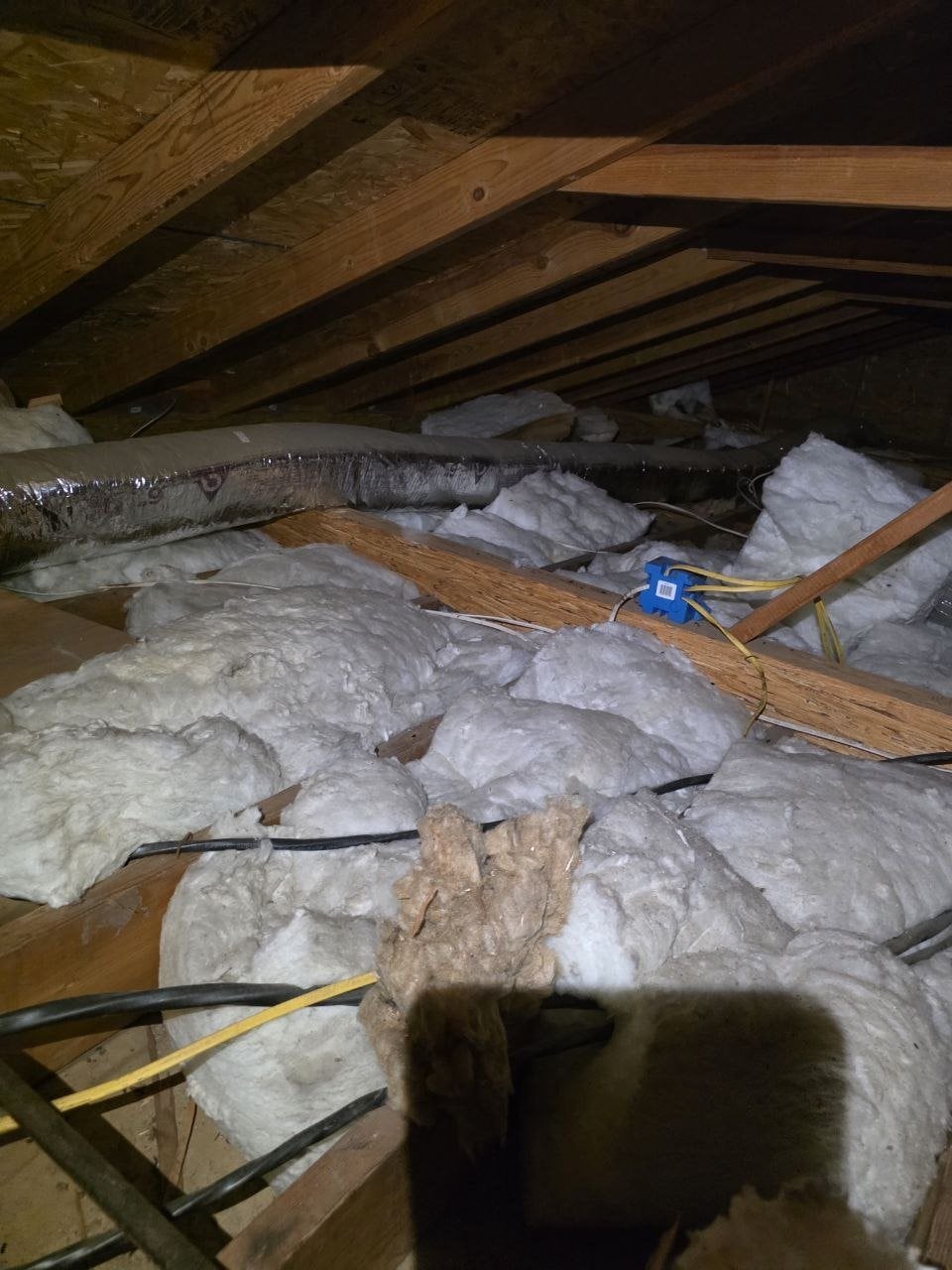 Another area of old insulation in the Fremont attic before work