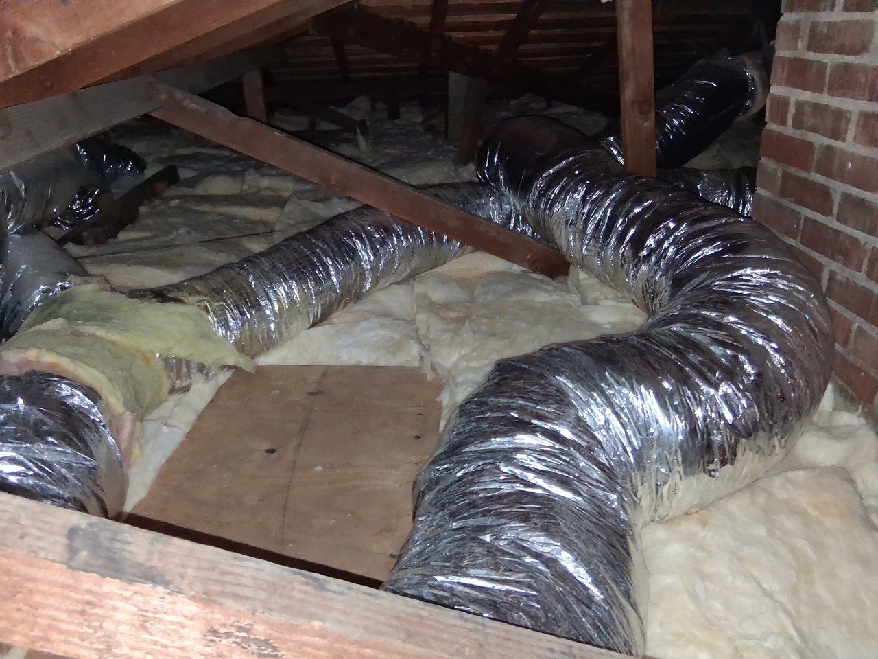 New insulation laid around ducts in a Glendale attic