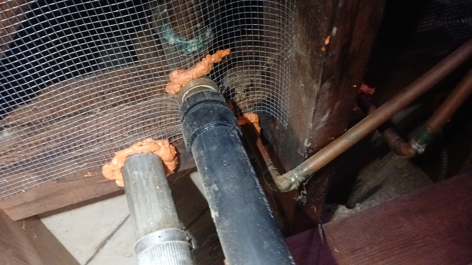 Wire mesh and foam around pipes in a Glendale crawl space