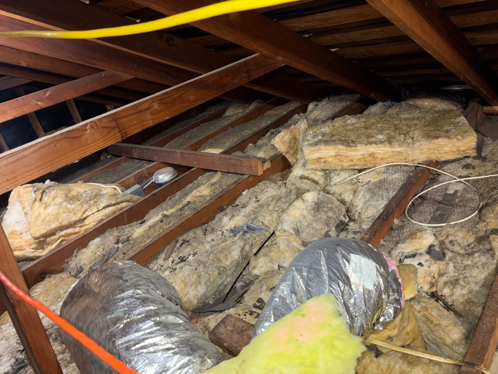 Old air ducts in old insulation in a Hacienda Heights attic before work