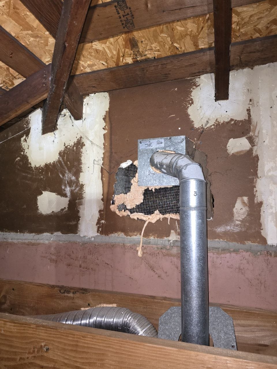 Wire mesh and foam around a pipe in a Hayward attic