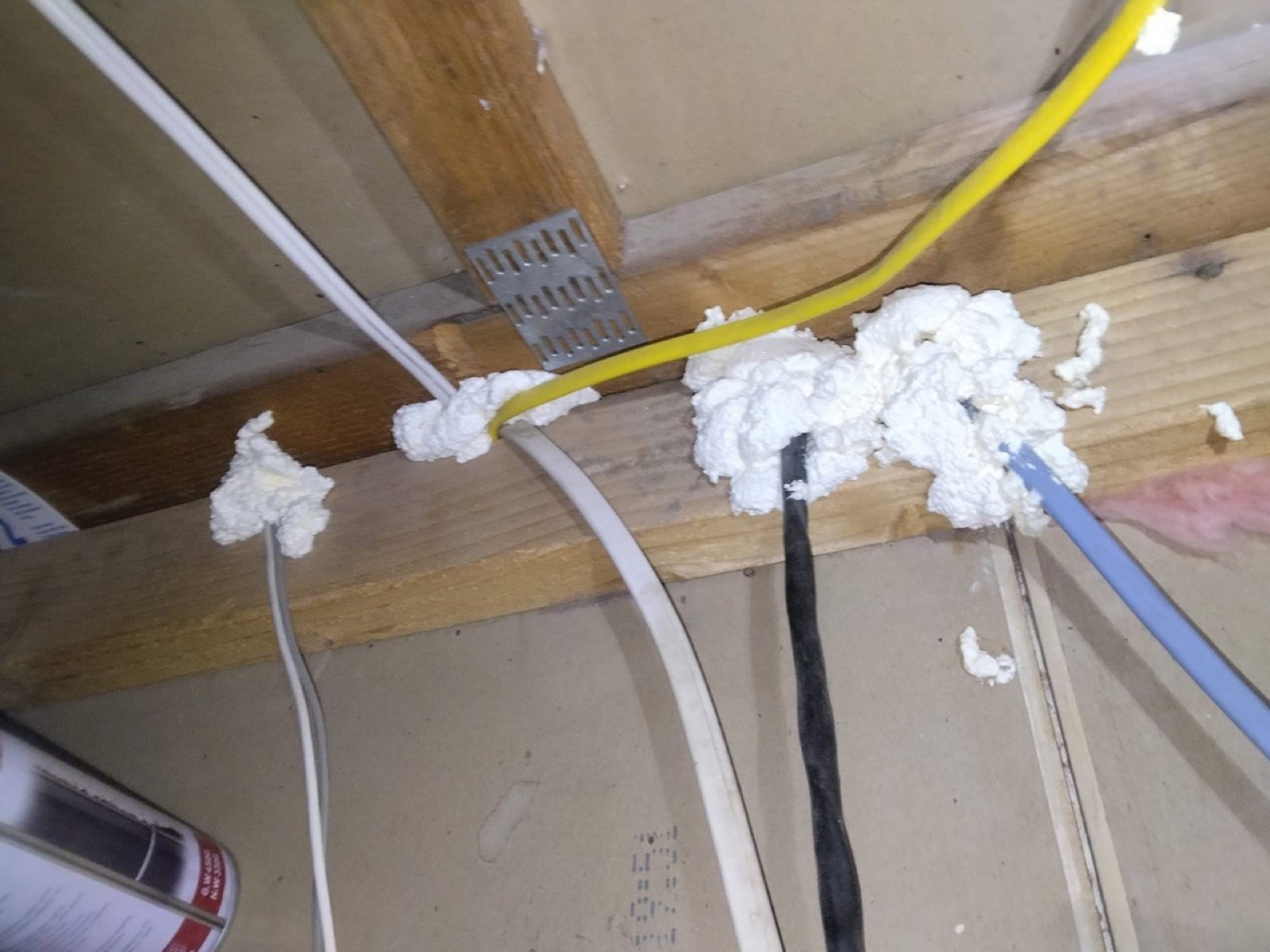 Calabasas attic air sealing, foam packed around cables running through the framing