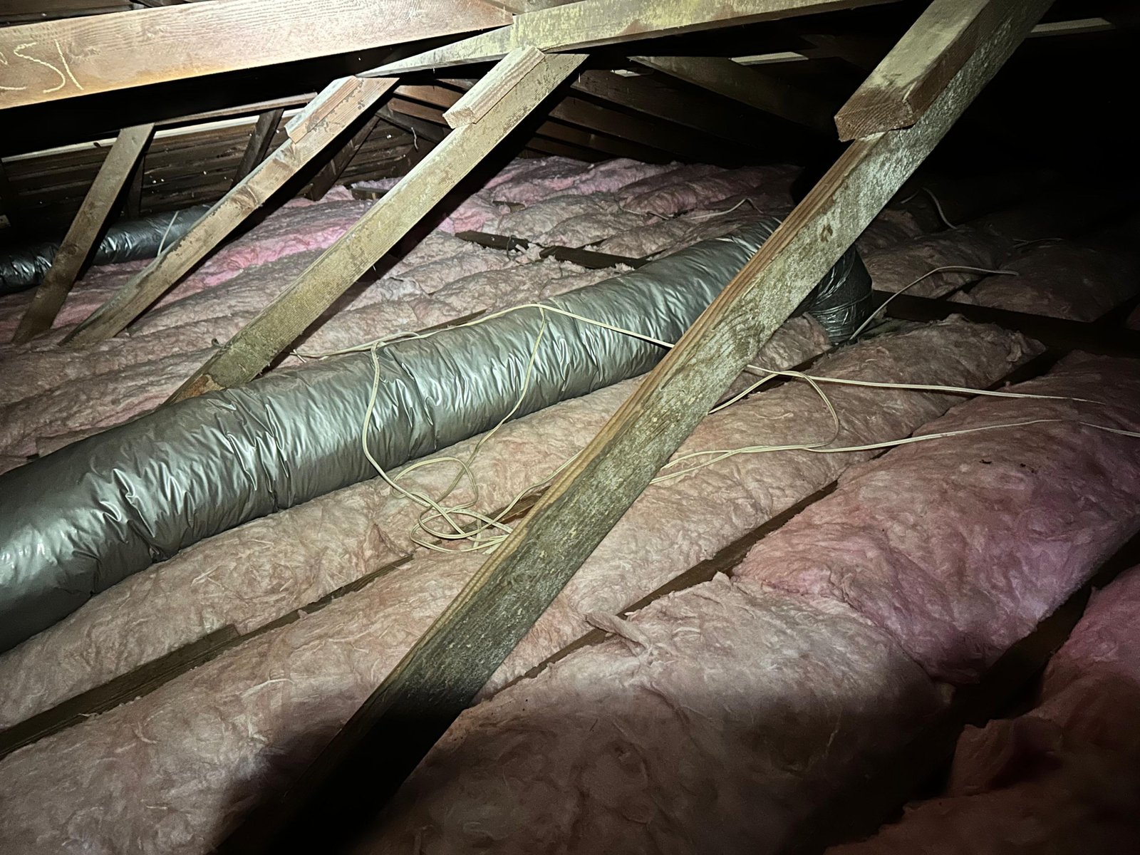 New insulation laid around ducts in a Long Beach attic