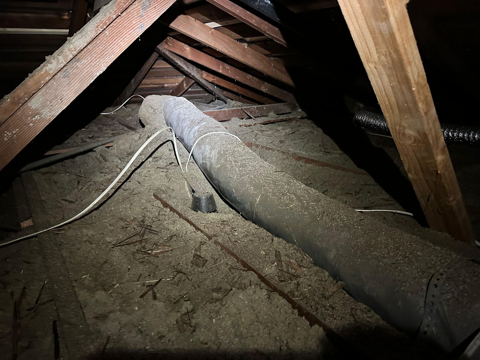 Long Beach attic before work, old insulation and debris
