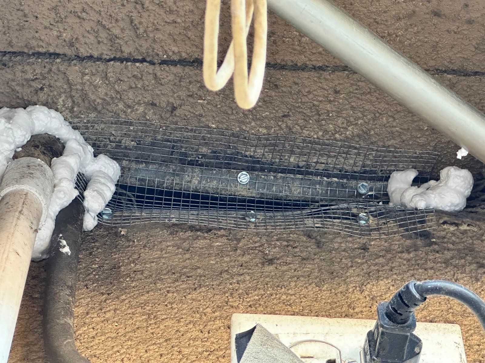 Foam air sealing around an attic penetration in Long Beach