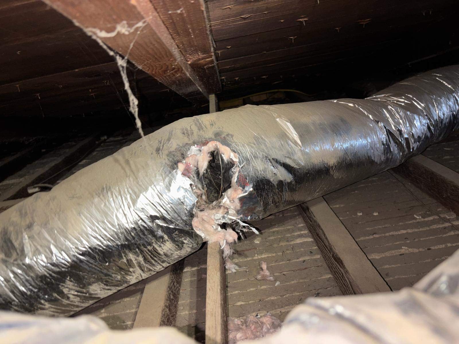 Torn old air duct in a Long Beach attic before work