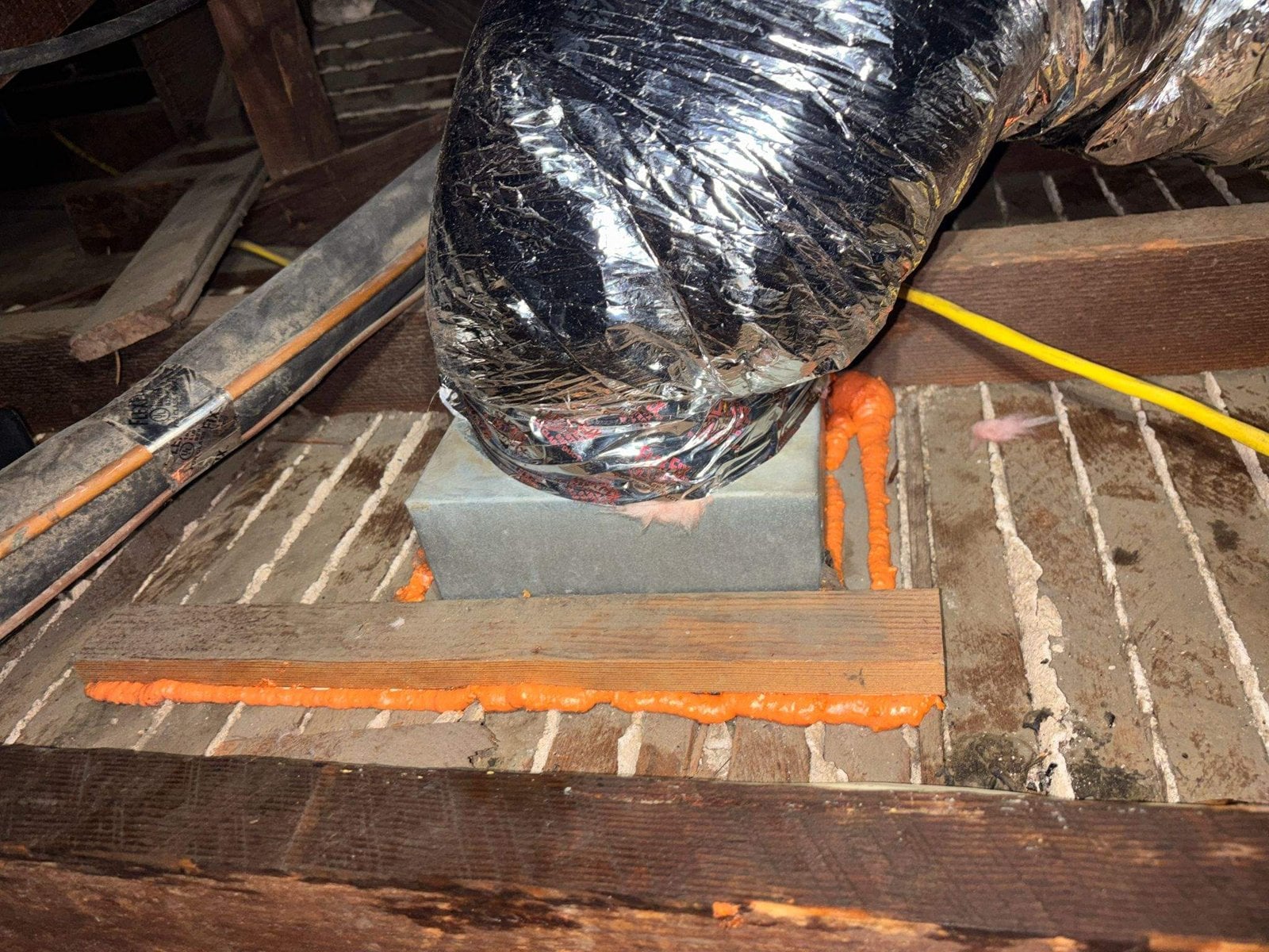New flexible air duct at a foam-sealed boot in a Long Beach attic