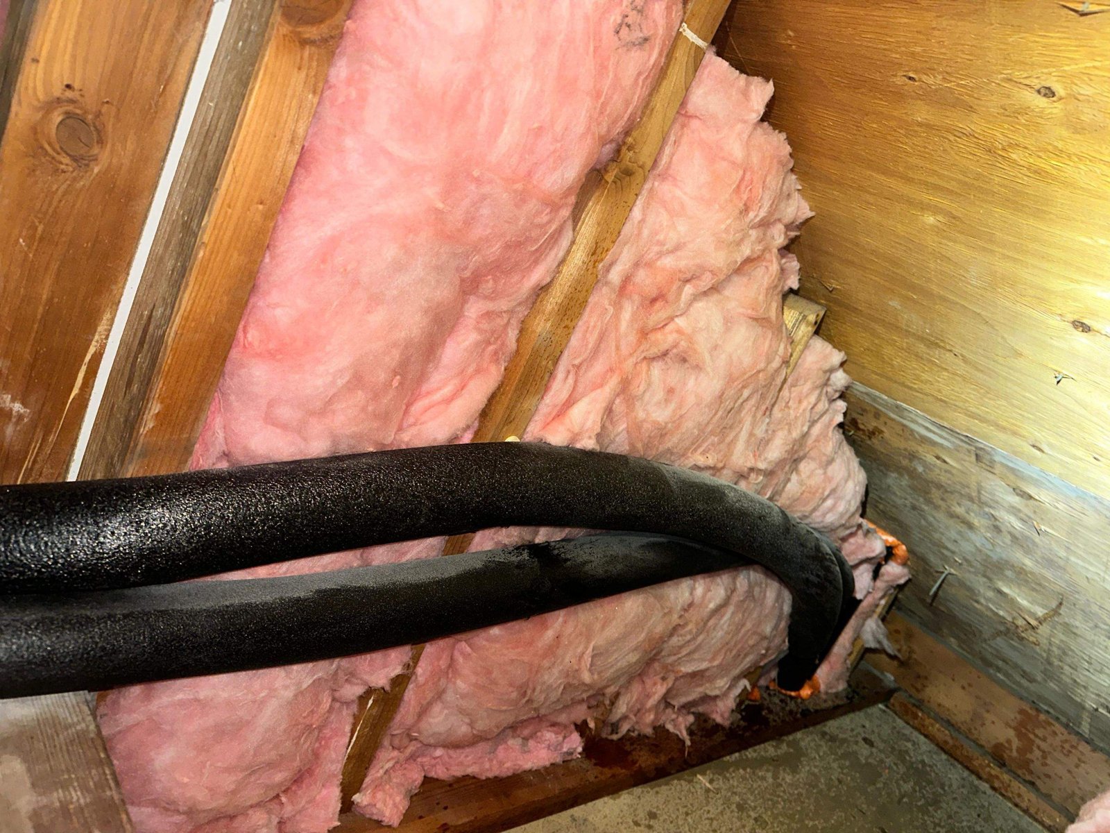New insulation batts between attic wall studs in Long Beach