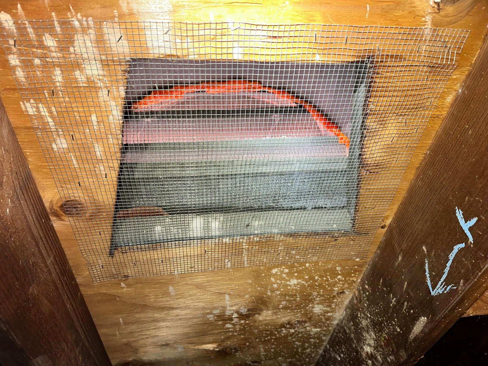 Attic vent sealed with wire mesh and foam in Long Beach