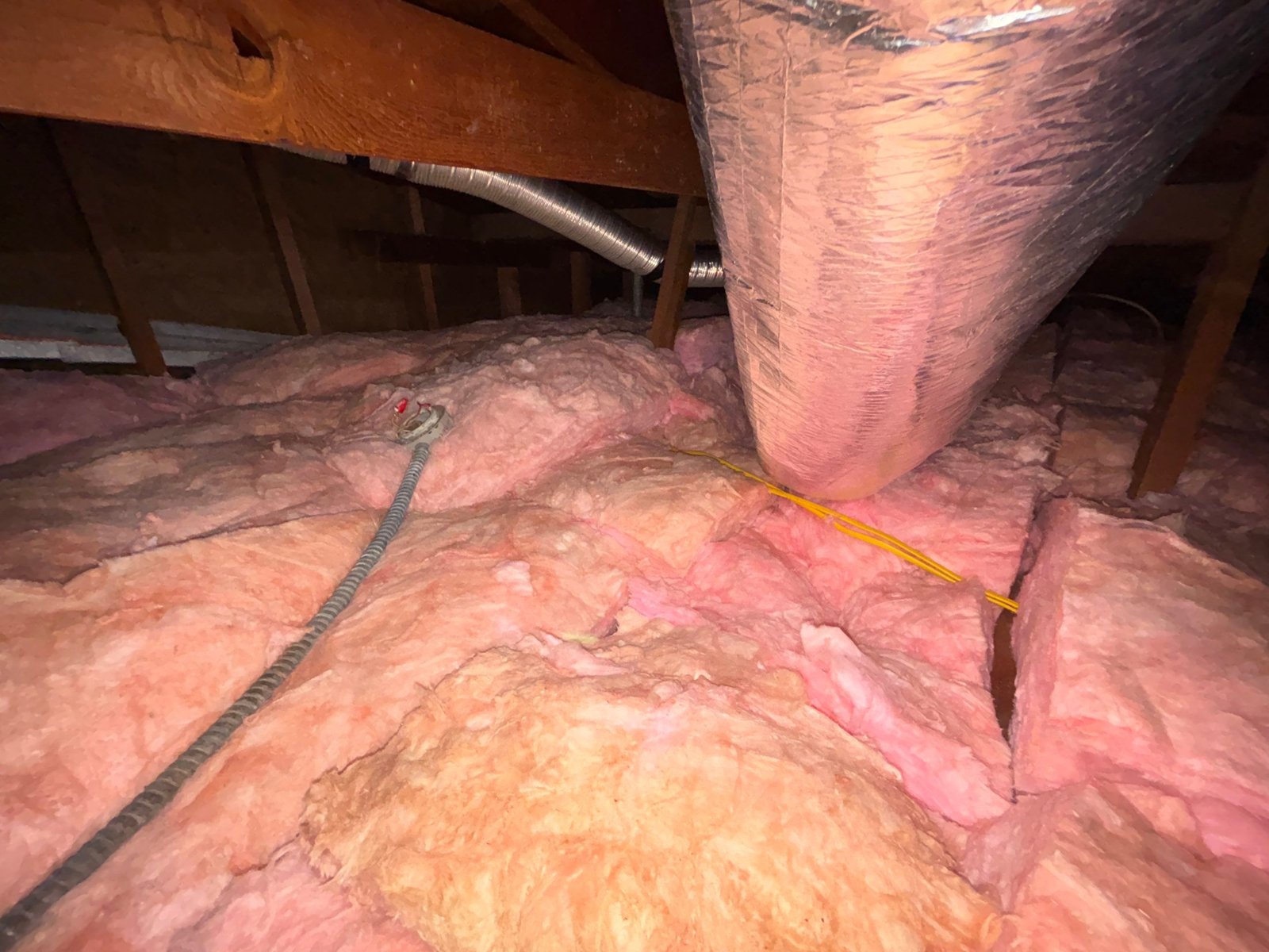 New insulation laid around ducts in a Los Angeles attic