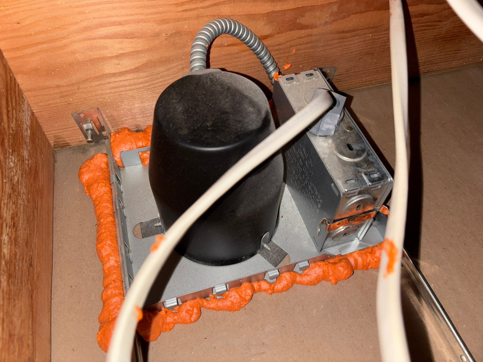 Foam air sealing around a fixture housing in a Los Angeles attic