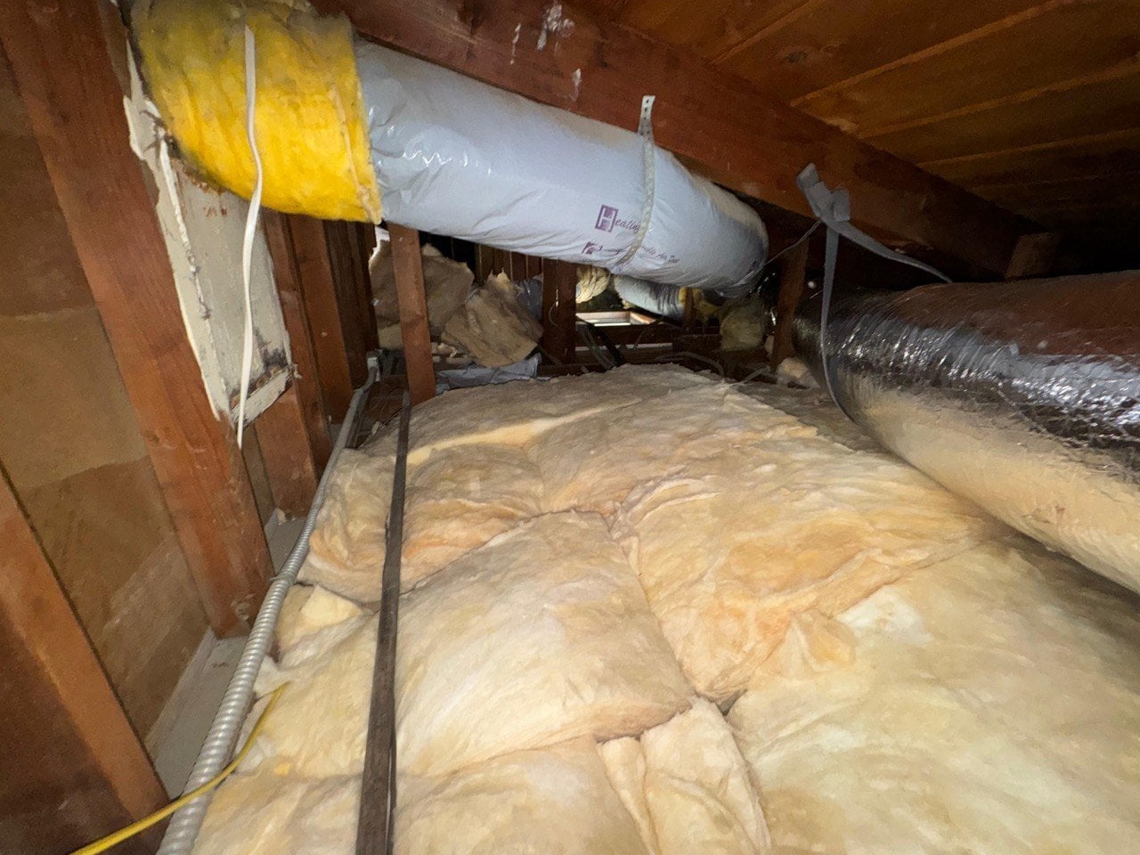 New insulation laid around ducts in a Los Angeles attic