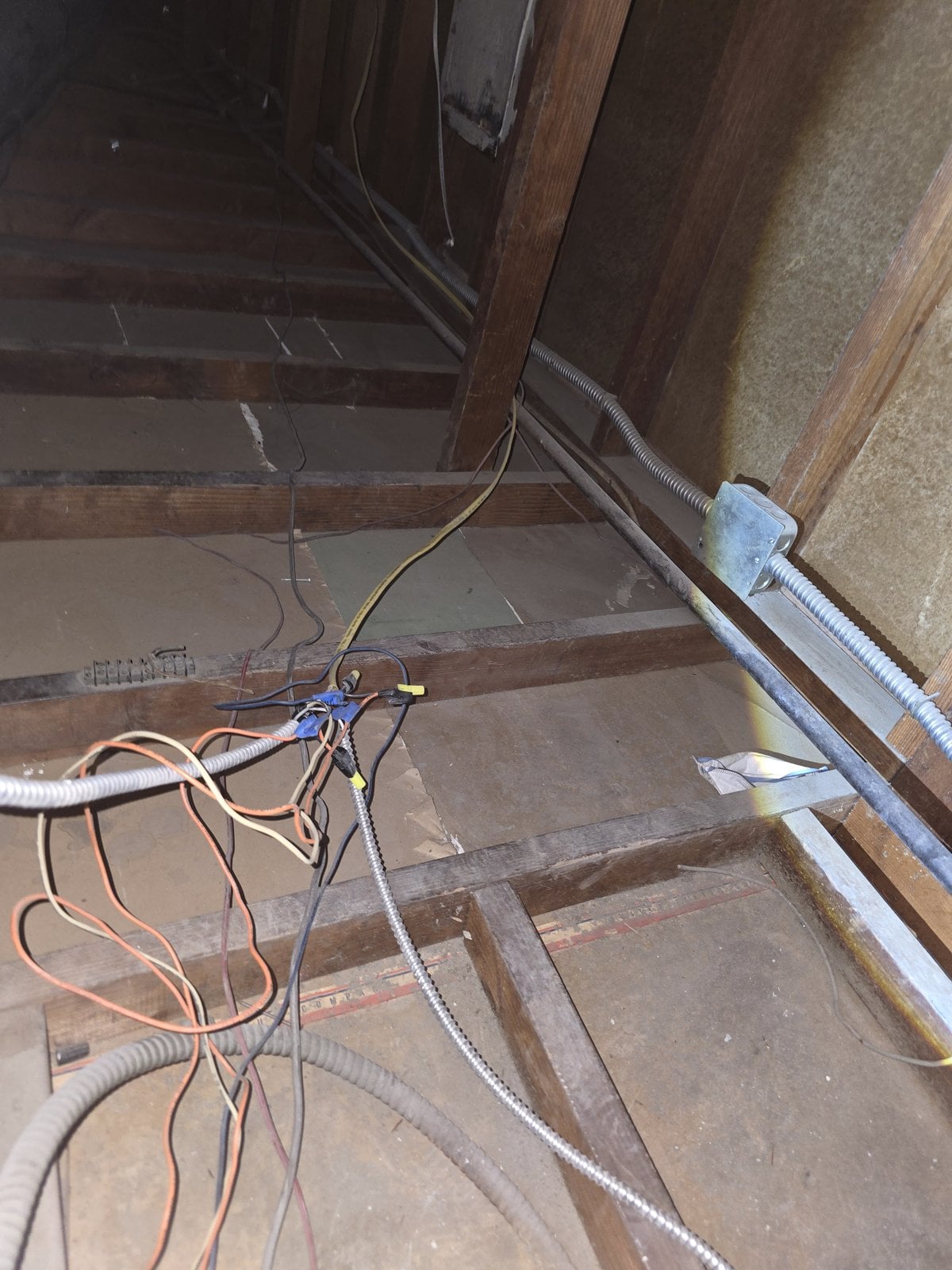 Attic deck and wiring in a Los Angeles attic before work