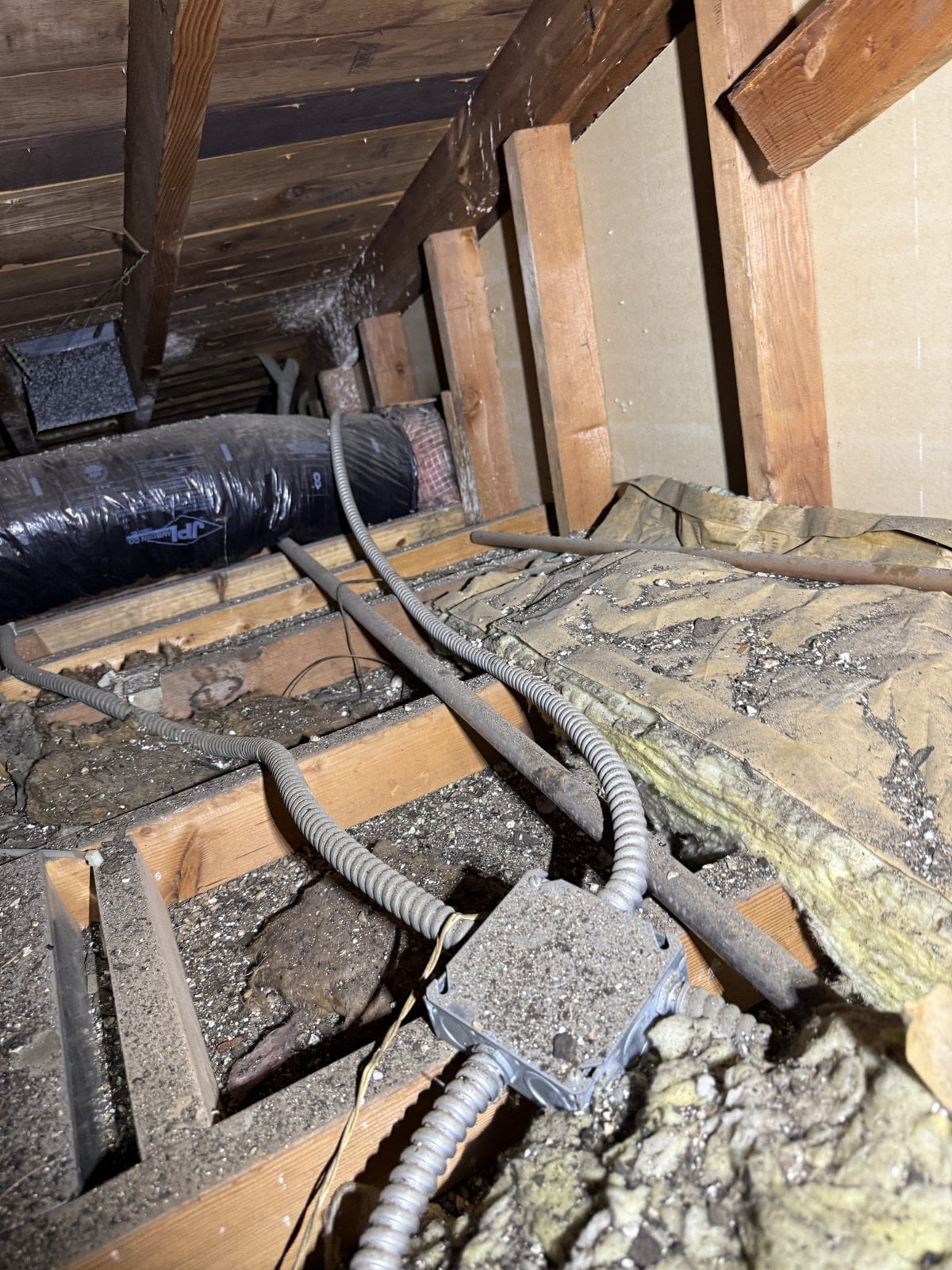Los Angeles attic before work, old insulation and debris