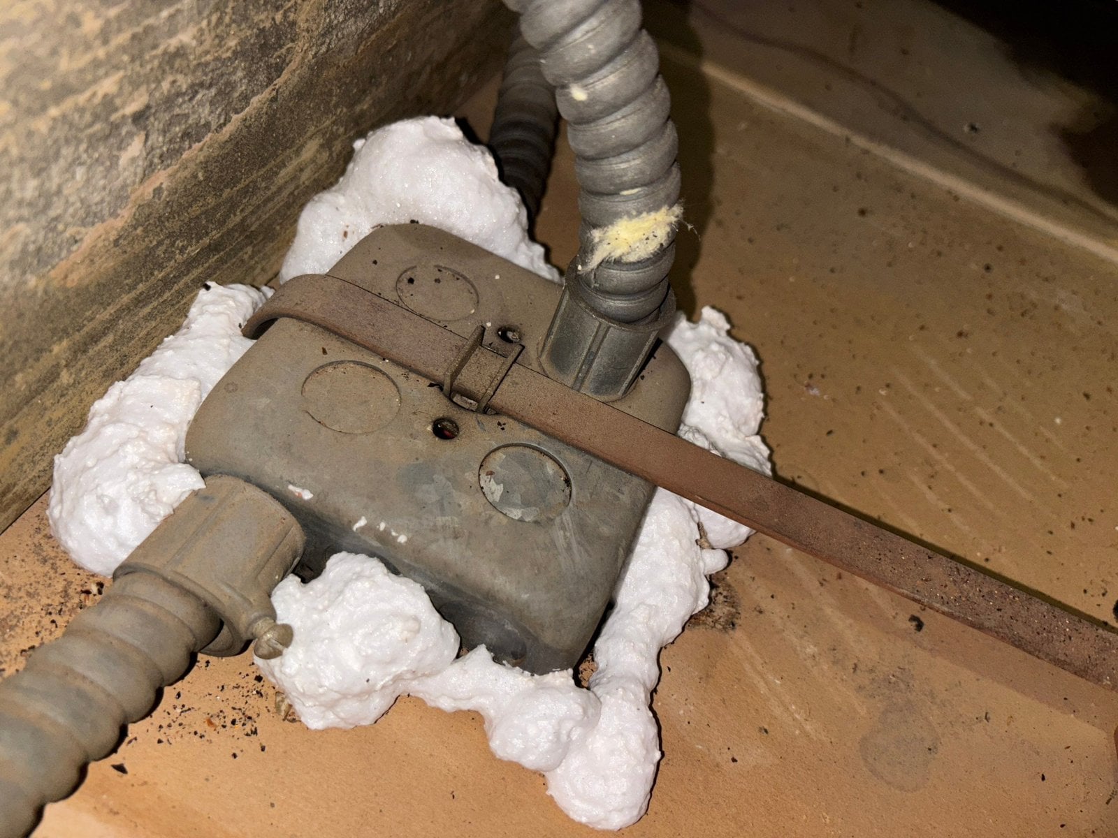 Foam air sealing around an electrical box in a Los Angeles attic