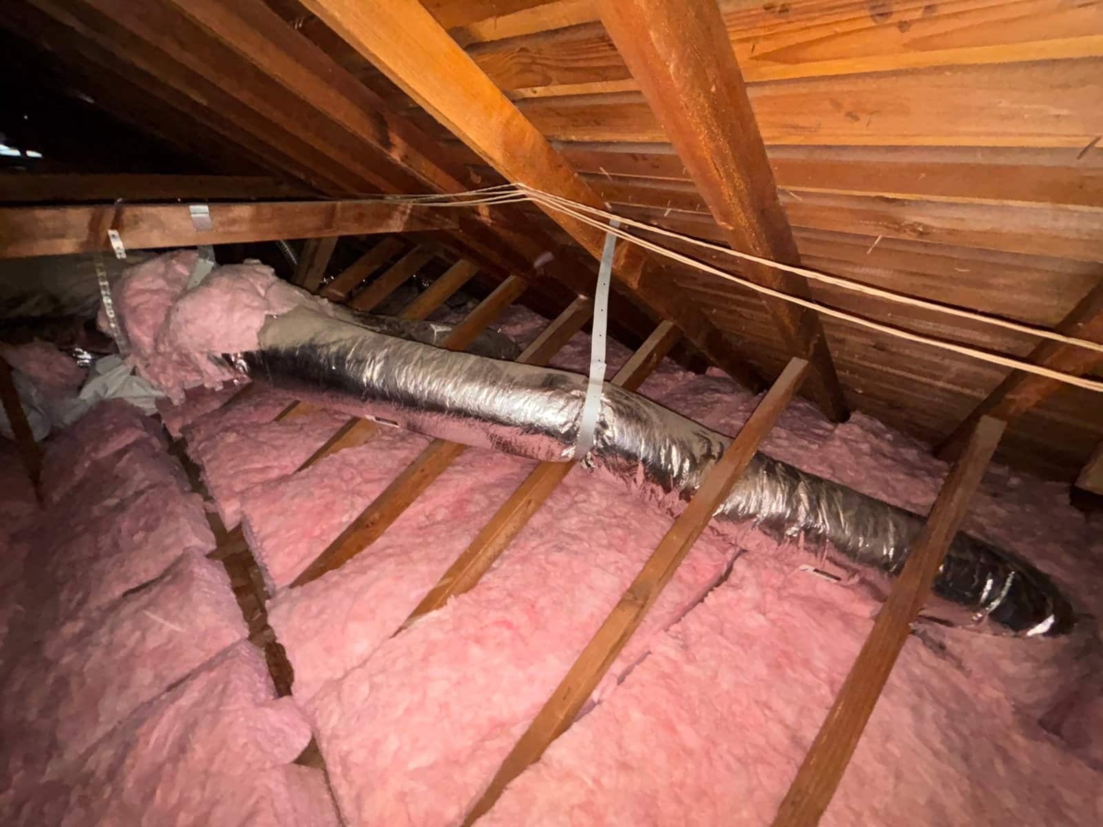 New insulation laid around ducts in a Los Angeles attic