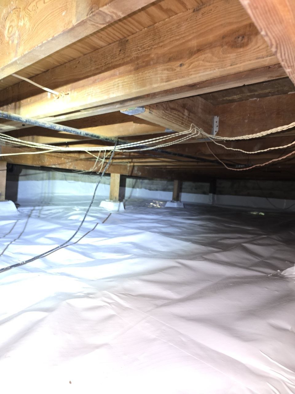 New vapor barrier between the piers of a Monte Sereno crawl space
