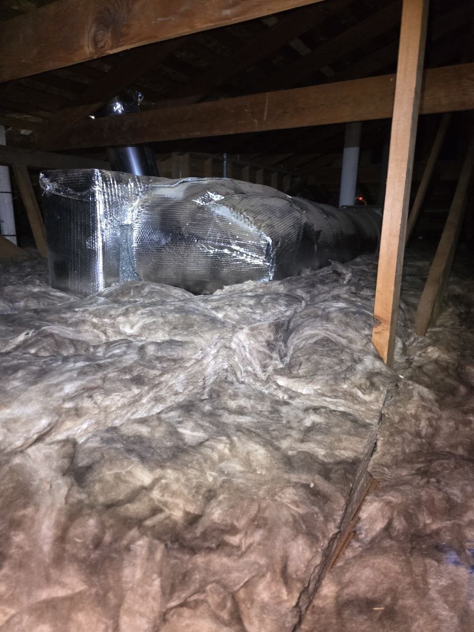 New insulation laid around ducts in a Oakland attic