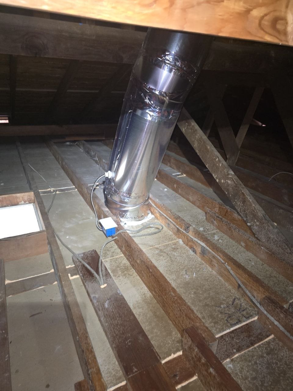 Cleaned attic deck around a flue pipe in Oakland