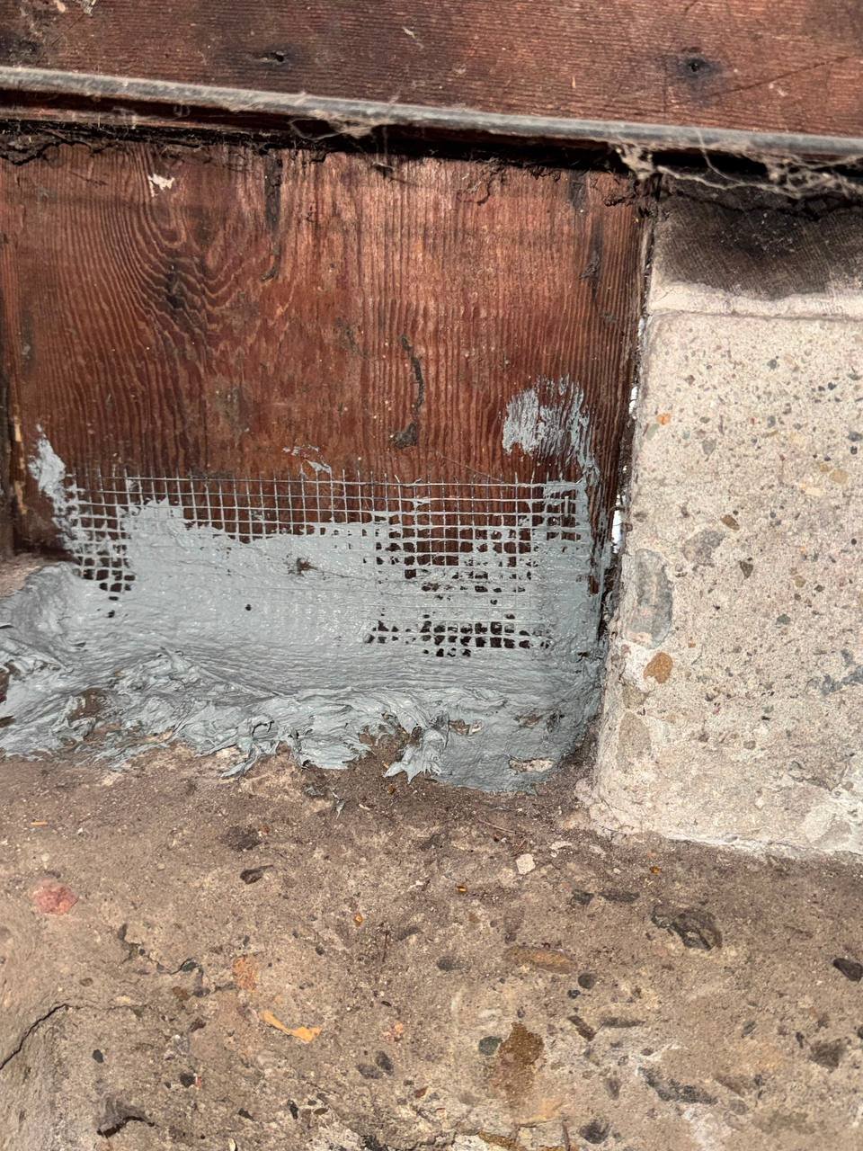 Wire mesh and cement sealing an opening in a Oakland home